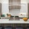 a kitchen with a white counter top and a wood cabinet