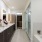 a bathroom with a tub sink and a mirror